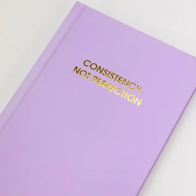 Consistency Not Perfection | Lilac Hardcover Journal Cards Chez Gagné  Paper Skyscraper Gift Shop Charlotte